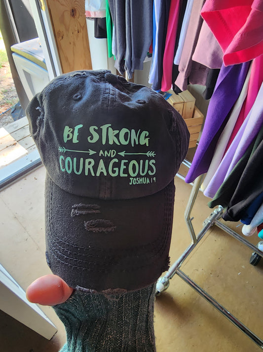 Christian hat that states Be strong and Courageous Joshua 1:9 with two arrows
