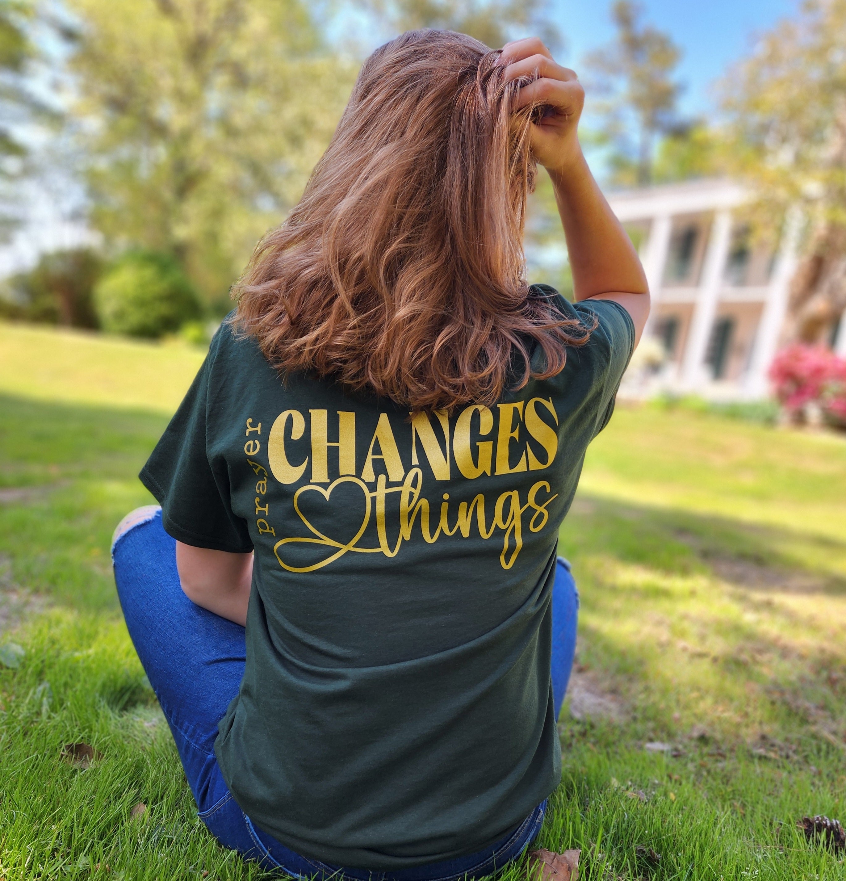 Army green Christian apparel shirt that says prayer changes things in yellow writing