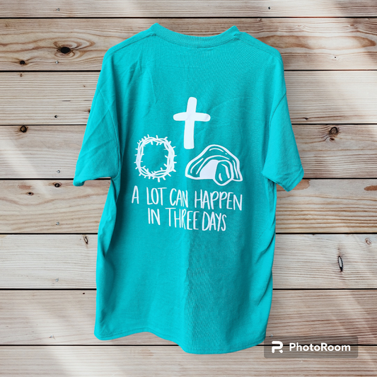 turquoise t-shirt with cross, crown of thorns, and opened tomb with a lot can happen in three days christian tee shirt